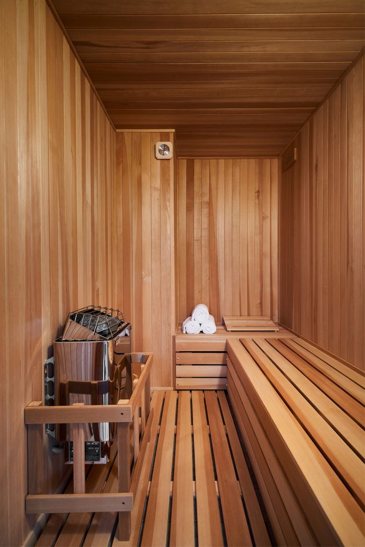 Purpose-built cedar sauna interior with heater and tiered benches